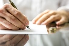 Signing divorce papers - Peoria Divorce Attorney